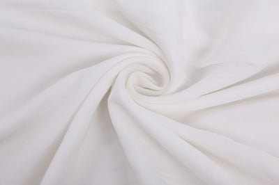 a white blanket with a white blanket on top of it 