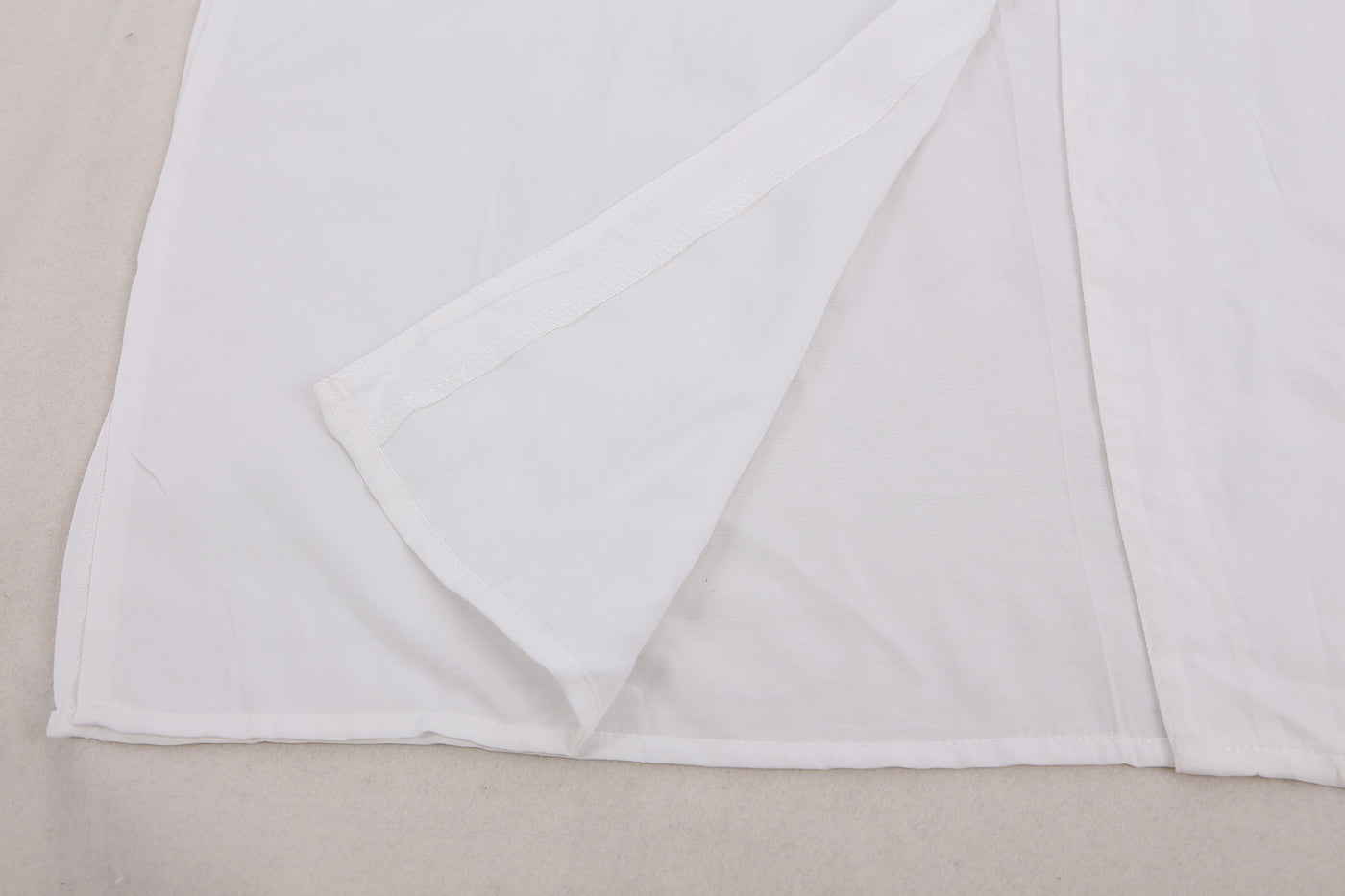 a white sheet with a white blanket on top of it 