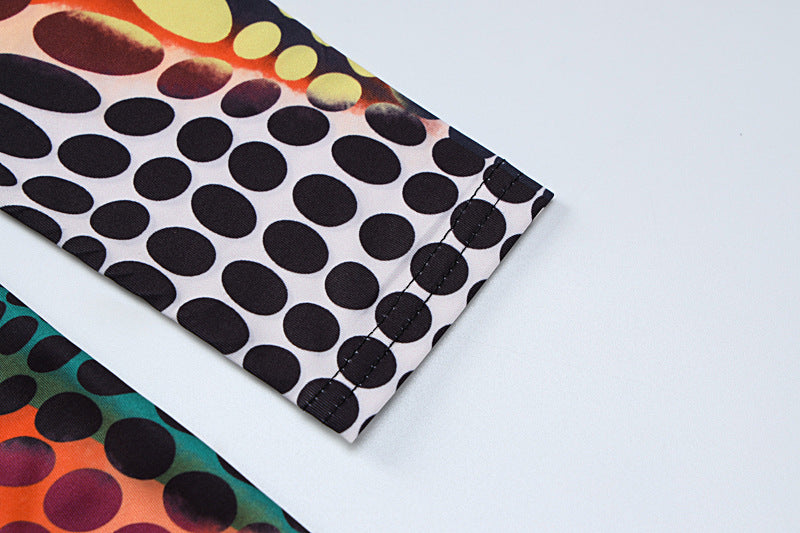 a black and white polka dot umbrella sitting on top of a table 