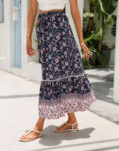 a woman in a dress walking down a street 