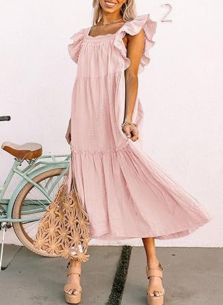 a girl in a pink dress holding a tennis racquet 