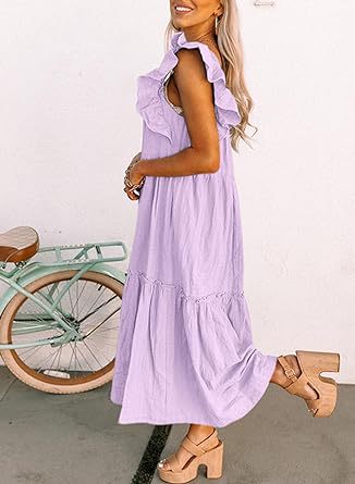 a woman in a pink dress standing next to a bike 