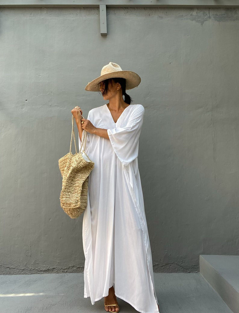 a man in a white dress is wearing a hat 