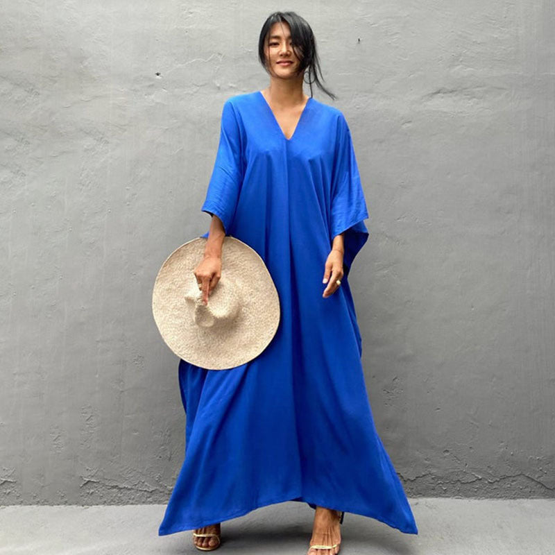 a woman in a blue dress holding a plate of food 