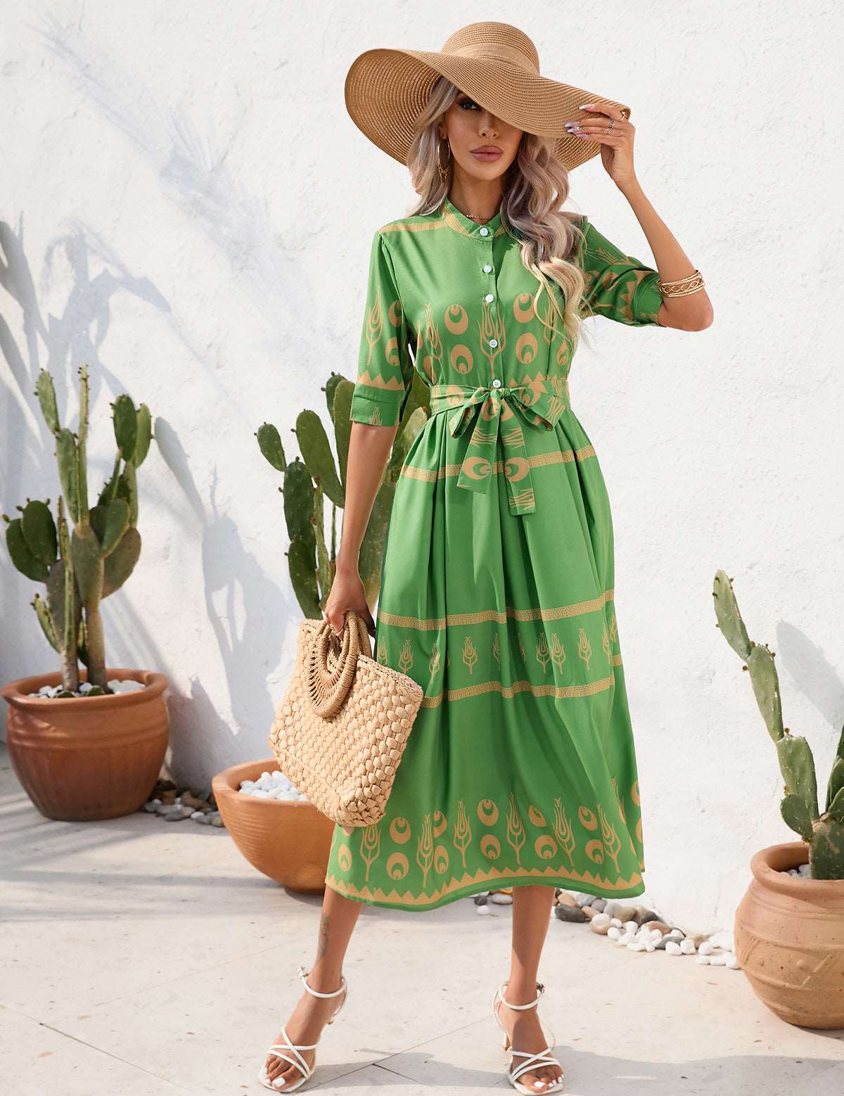 a woman in a green dress holding an umbrella 