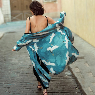 a woman in a blue dress riding a skateboard 