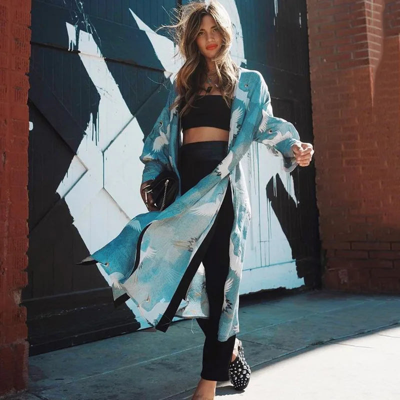 a woman holding a skateboard on a sidewalk 